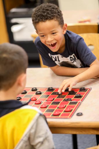 Students playing checkers