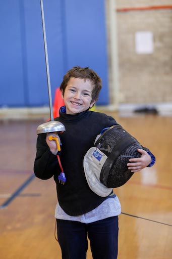 Student posing in fencing class
